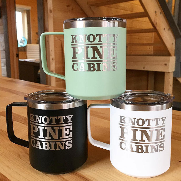 LAMOSE insulated stainless steel mugs in mint green, black, and white, featuring a custom KNOTTY PINE CABINS logo, front view.