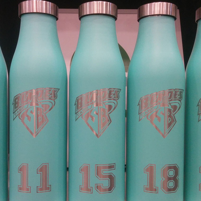 LAMOSE custom teal stainless steel insulated water bottles, front view. Engraved with 'Blades St. Albert SB' logo and numbers 11, 15, 18.