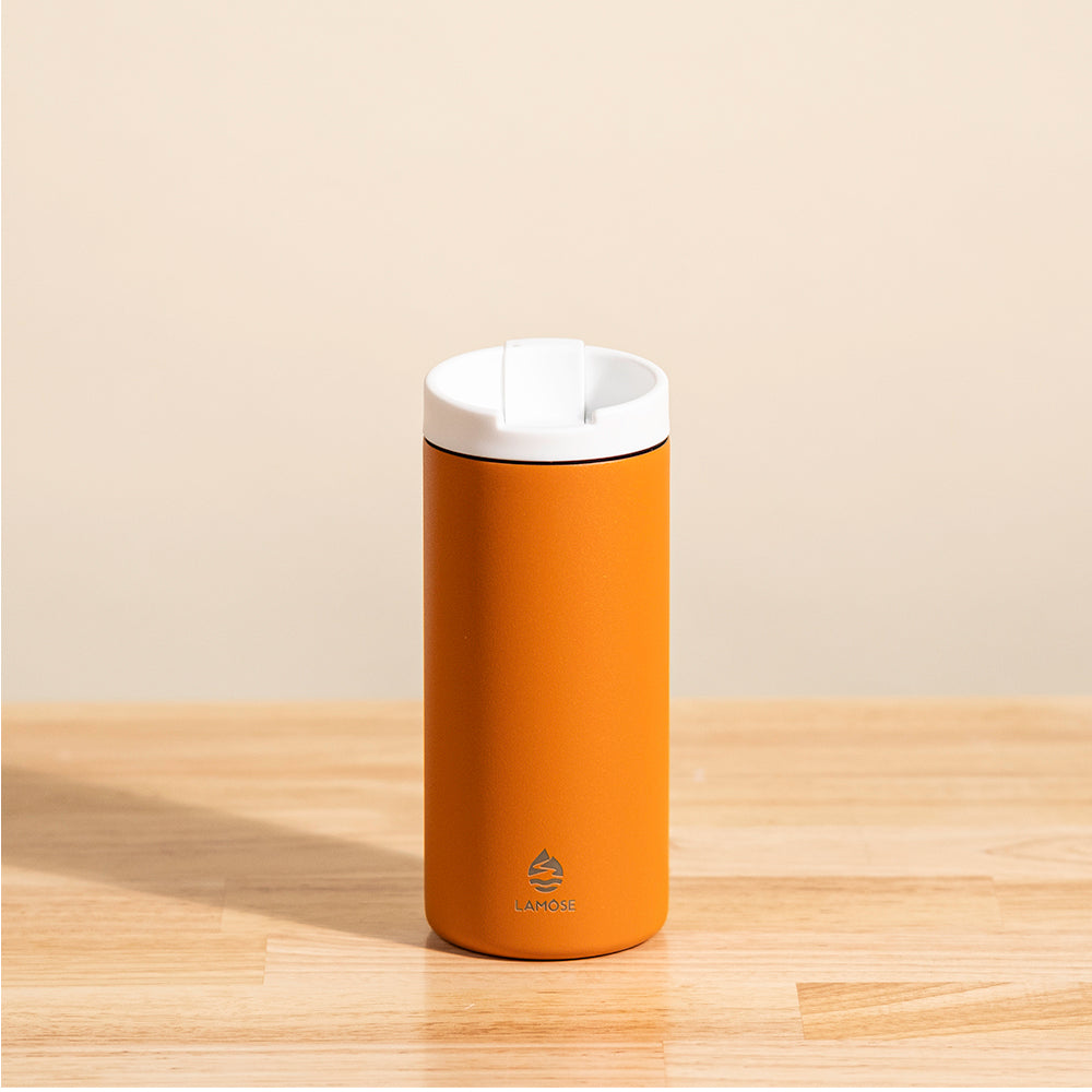 LAMOSE Grouse 12 oz insulated tumbler in matte orange, stainless steel, front view. White leakproof flip-top lid and LAMOSE logo visible.