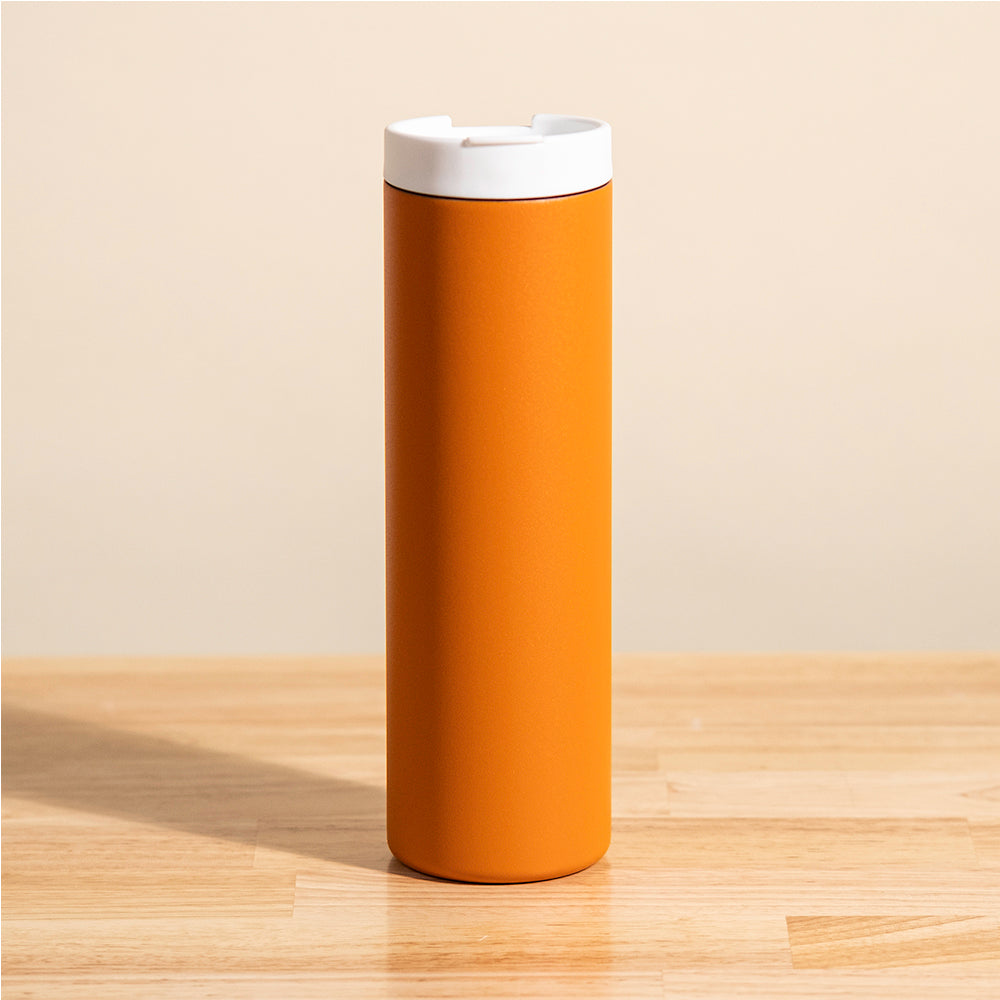 LAMOSE Grouse 20 oz insulated tumbler in vibrant orange, featuring a matte finish and a contrasting white lid, viewed straight on.