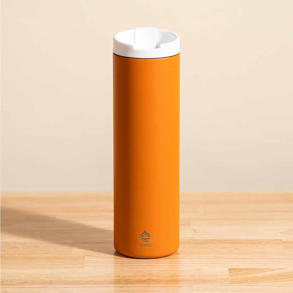 LAMOSE Grouse 20 oz insulated tumbler in vibrant orange, matte stainless steel, front view, with white flip-top lid and logo.