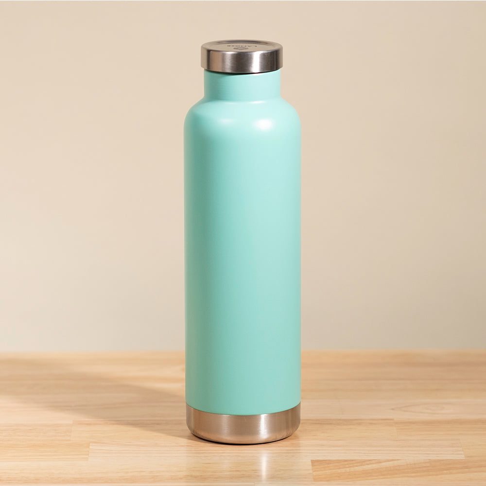 LAMOSE Moraine 27 oz insulated bottle in matte turquoise, standing upright on a wooden surface with a stainless steel cap and base.