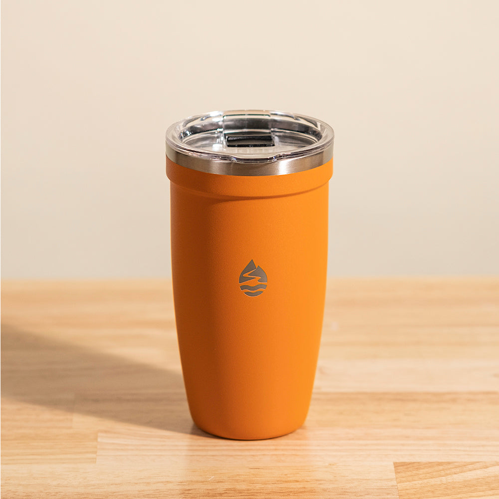 LAMOSE Peyto 16 oz orange matte stainless steel tumbler with clear lid, front view, showcasing the subtle brand logo.