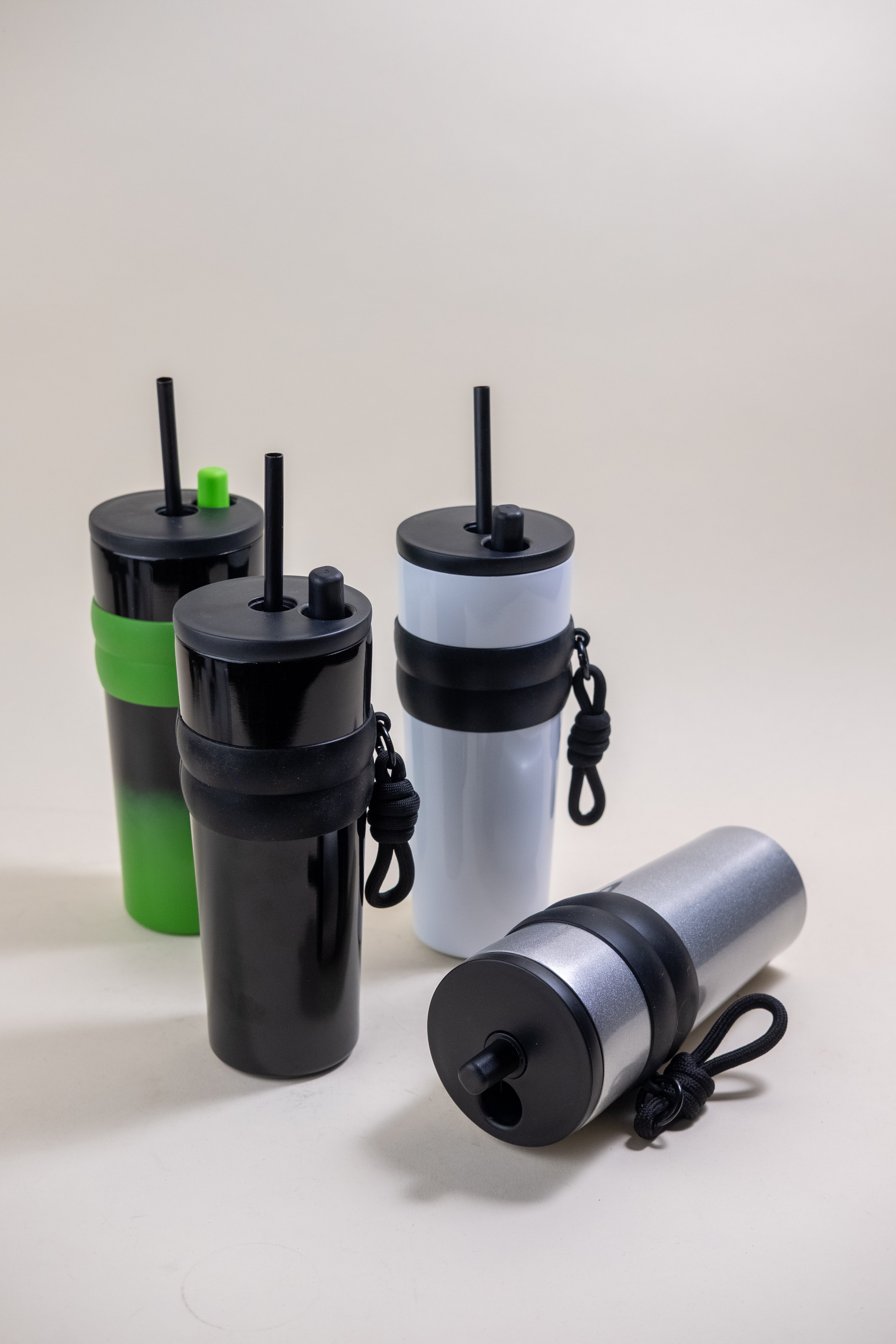 Collection of Straw Tumblers in various colors, featuring stainless steel construction, BPA-free plastic straws, and rubber holders, designed for customization and convenience.