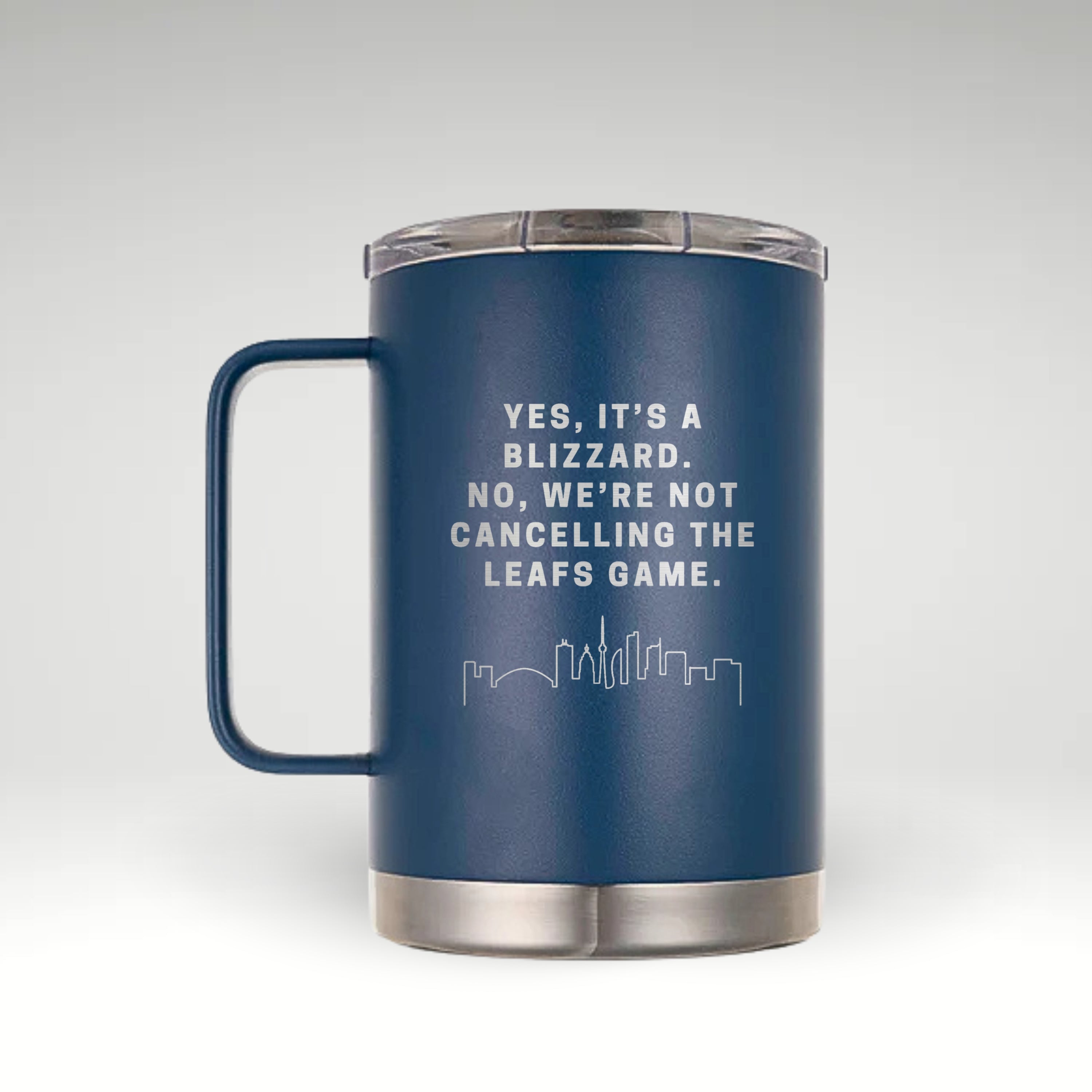 Classic Blue insulated mug with handle, featuring an engraved Toronto skyline and the phrase "Yes, it’s a blizzard. No, we’re not cancelling the Leafs game." Stainless steel bottom and clear lid.