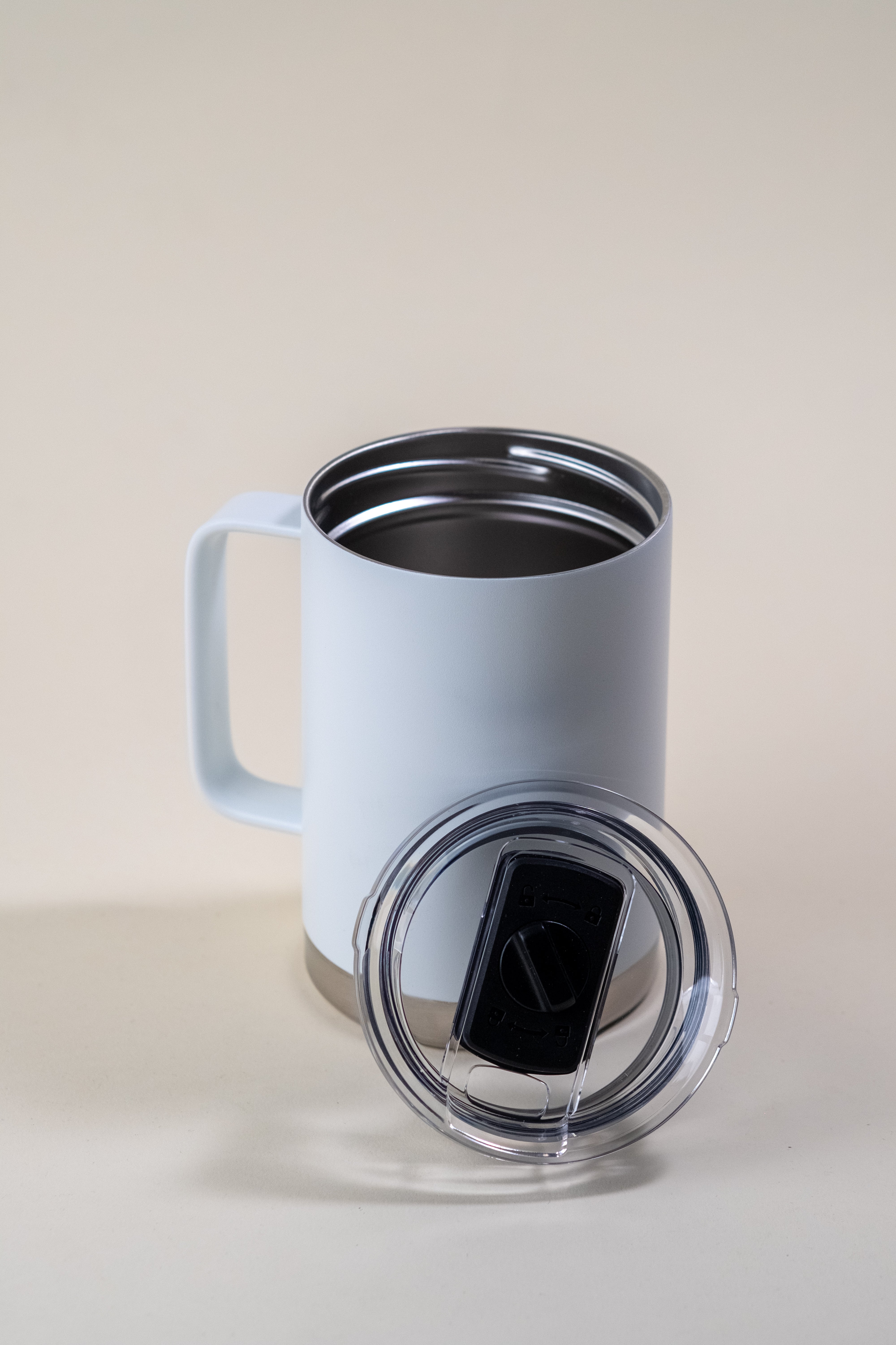 LAMOSE white insulated mug with handle, stainless steel interior, and clear lid with slider, viewed from a slight angle.