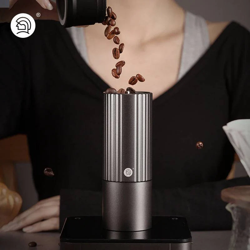 Stainless steel manual coffee grinder, preparing for a fresh brew