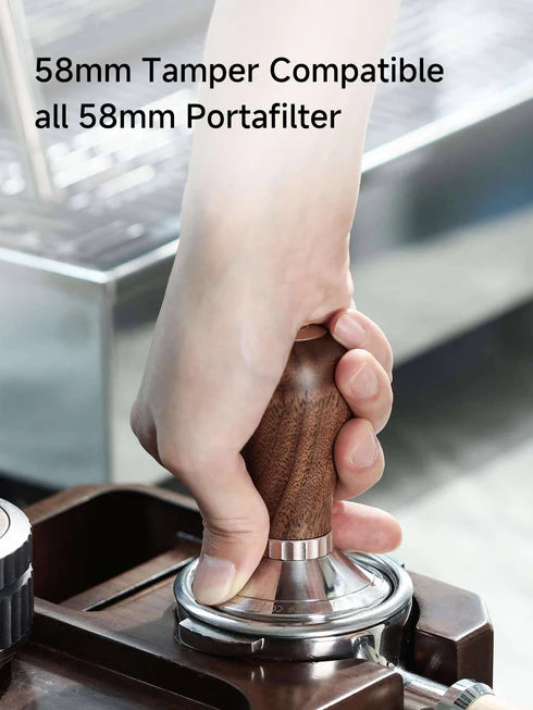 Barista using a zeroHero 58mm calibrated espresso tamper with a walnut handle, designed for compatibility with all 58mm portafilters for professional-quality coffee tamping. #color_mahogany