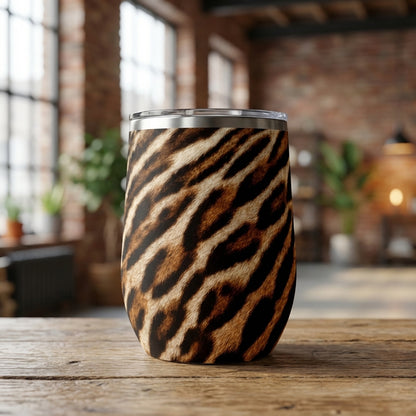 Close up of LAMOSE Whistler 16oz insulated wine tumbler featuring a beige and black tiger animal print pattern with a silver rim.