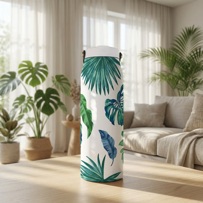 White 34 oz insulated tumbler featuring a green and blue tropical monstera and palm leaf pattern standing on a wooden surface.