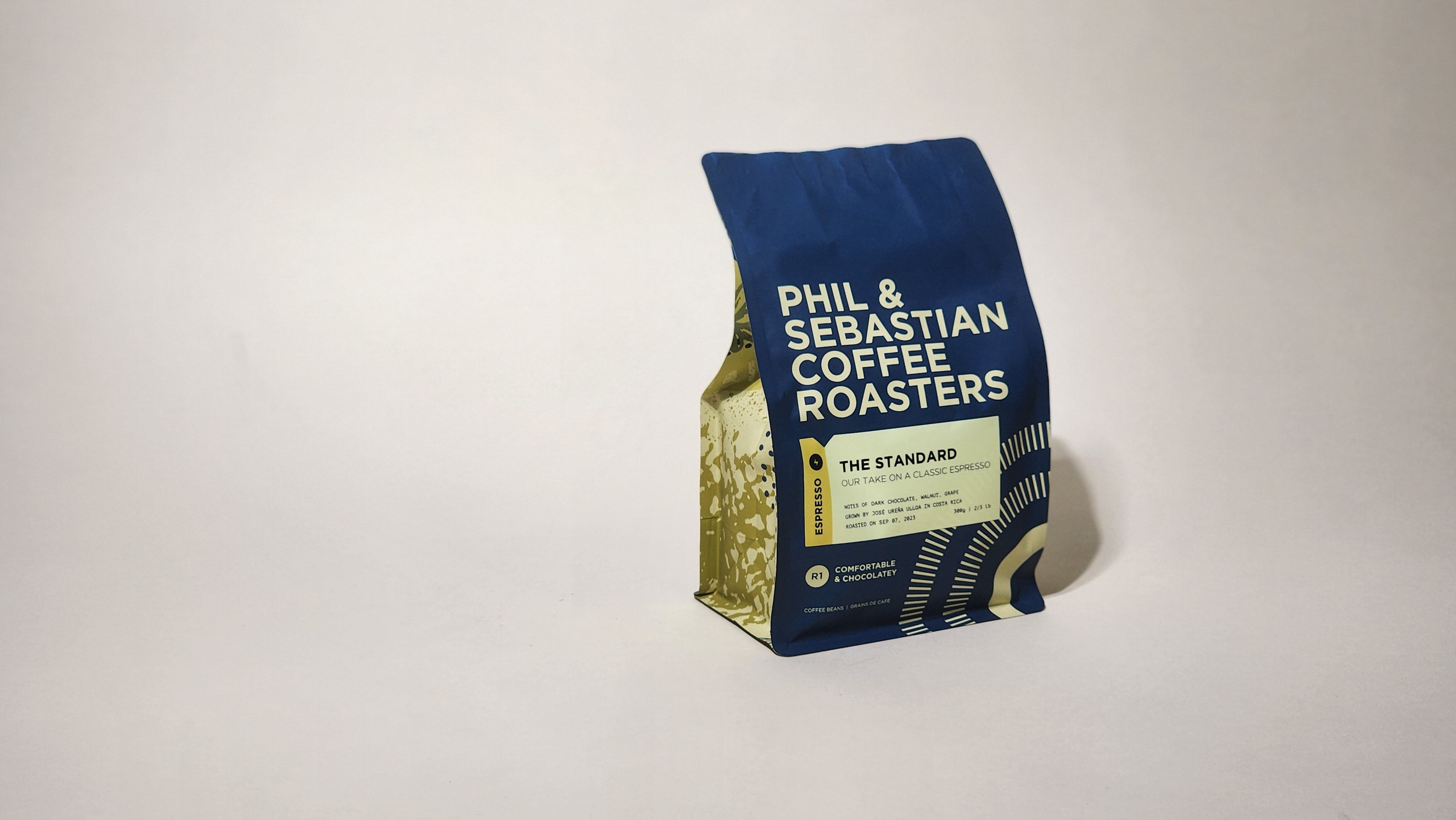 Phil & Sebastian Coffee Roasters' Standard Espresso. Consistent flavor profile with sweet, chocolatey, and nutty notes. Sourced from individual farms and co-ops. Brew with parameters optimized for espresso excellence.