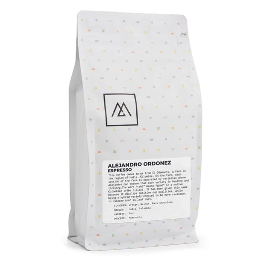 Monogram Coffee - Alejandro Ordonez: Discover the rich flavors of Huila, Colombia with Alejandro's meticulously cared-for Tabi variety coffee from El Diamante farm. Taste notes of orange, walnut, and dark chocolate in every espresso. Learn more about our commitment to quality and sustainability.