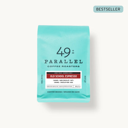 Old School Espresso by 49th Parallel Coffee Roasters. A medium-dark roast with flavors of caramel, dark chocolate, and nuts. Crafted from Indian Ratnagiri Estate and Colombian Tolima Organic beans for a rich and comforting espresso experience.