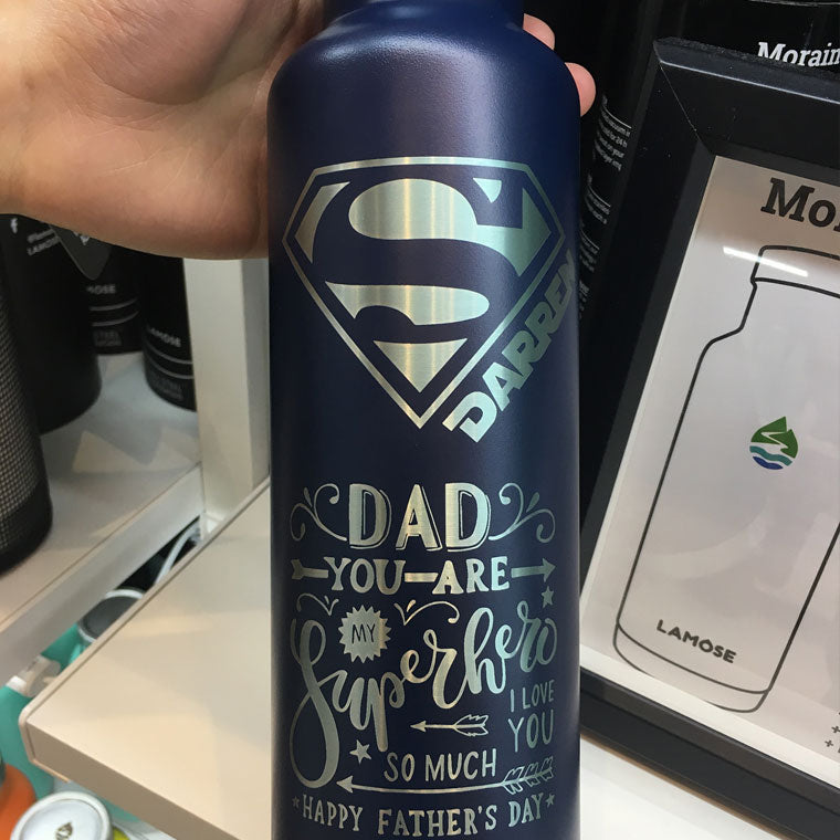 LAMOSE navy blue stainless steel insulated water bottle held in hand, featuring custom Superman 'S' DAD MY Superhero engraving.