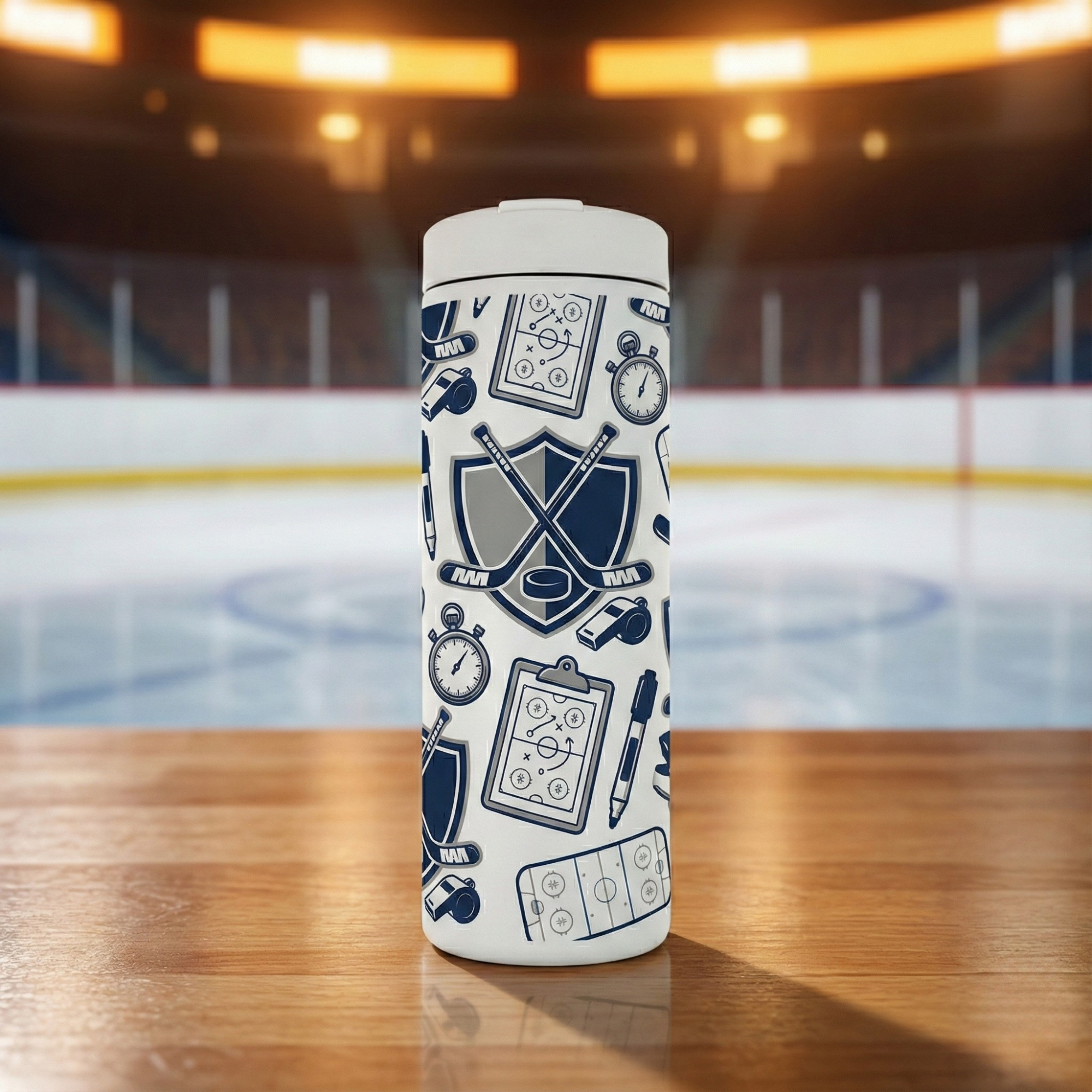 White 16 oz insulated tumbler featuring a navy blue pattern of hockey sticks, pucks, rink diagrams, stopwatches, and whistles.