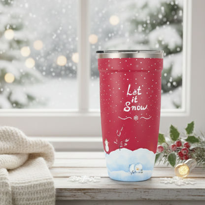 Red 16oz stainless steel tumbler with white Let It Snow script, snowflakes, and snowmen design on a wooden table with holiday decor