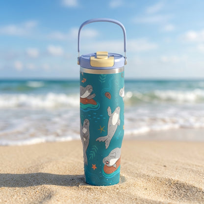 Teal LAMOSE Cascade 40oz tumbler featuring a playful pattern of gray seals, starfish, and seashells with a light blue handle and lid.