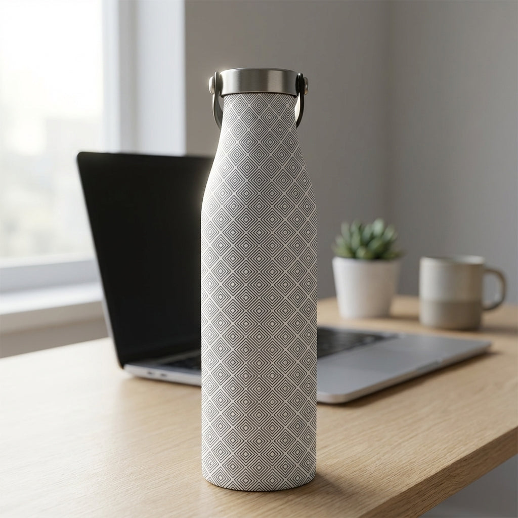 Robson 21oz insulated stainless steel bottle featuring a grey concentric square diamond pattern standing on a wooden office desk next to a plant.