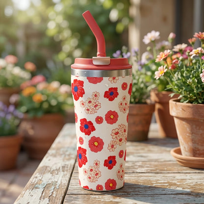 Cream 16 oz insulated tumbler featuring red floral pattern and water droplets in a sunny garden setting