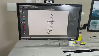 Personalized turquoise stainless steel water bottle with the name 'Martina' elegantly engraved, held in a gloved hand against a backdrop of premium drinkware.