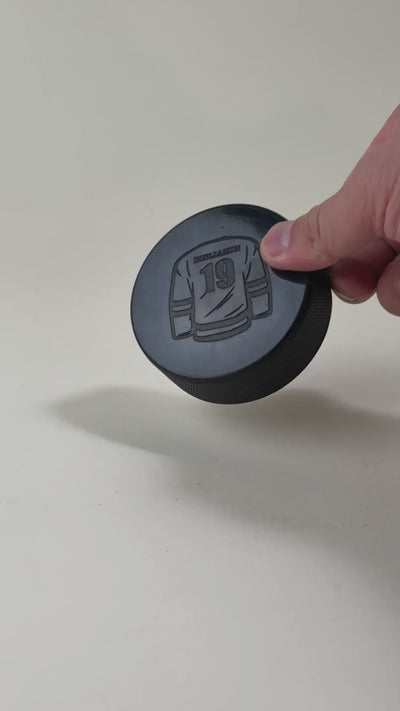 Engraved hockey puck featuring a custom design and personalized text. High-quality laser-etched puck, ideal for coaches, players, and team memorabilia.
