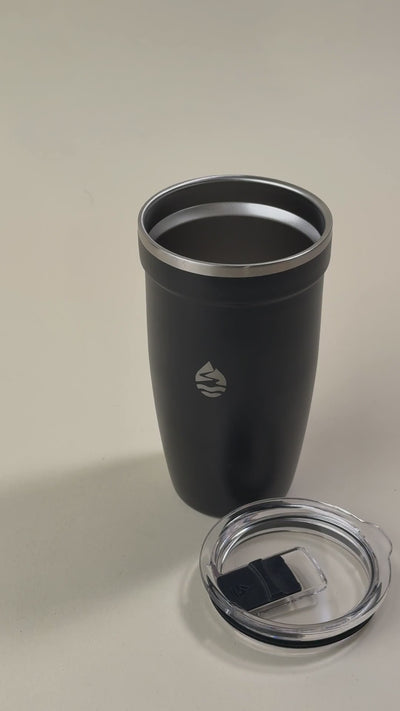 Black insulated stainless steel tumbler with a clear spill-resistant lid, featuring a sleek design and a minimalist engraved logo.