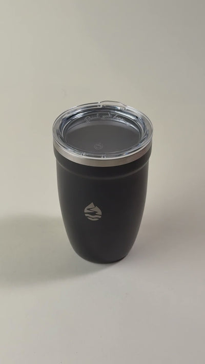 Black insulated tumbler with a clear spill-resistant lid. Sleek stainless steel travel mug designed to keep beverages hot or cold for extended hours.