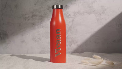 Four stainless steel water bottles in vibrant colors—turquoise, orange, pastel green, and beige featuring a minimalist engraved logo.