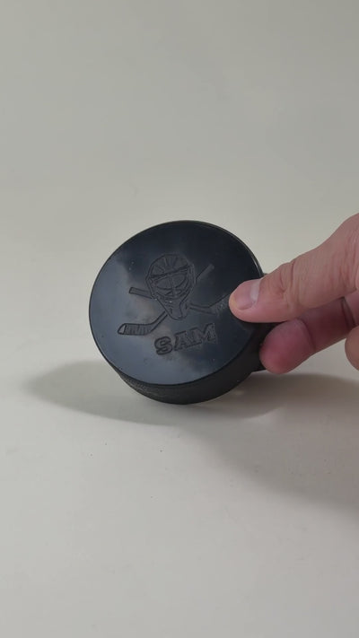 Personalized hockey puck with custom laser engraving, featuring unique designs and text. Ideal for coaches, players, and team keepsakes.