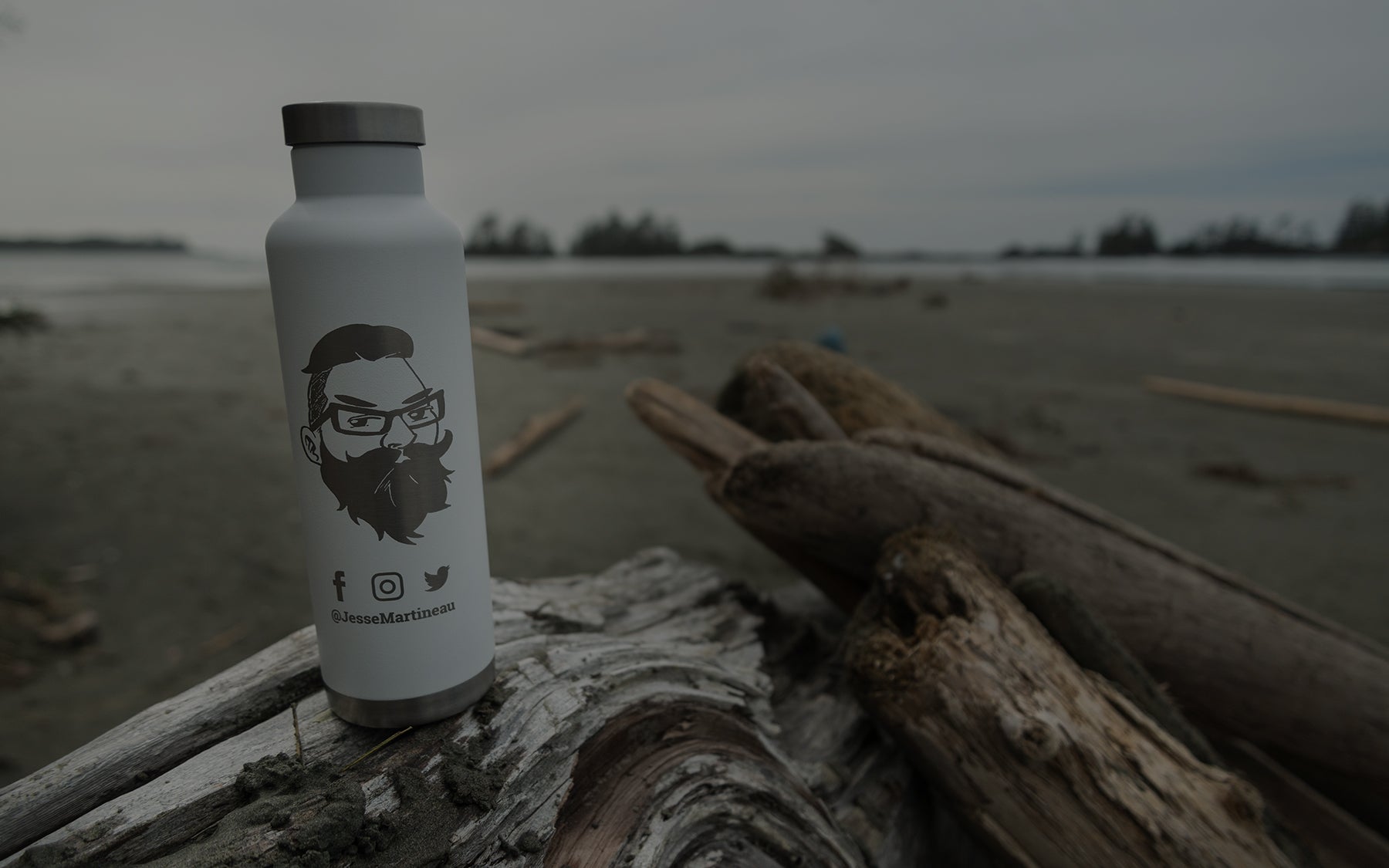 LAMOSE light grey insulated water bottle with custom engraved bearded man design and social media handles, on driftwood.